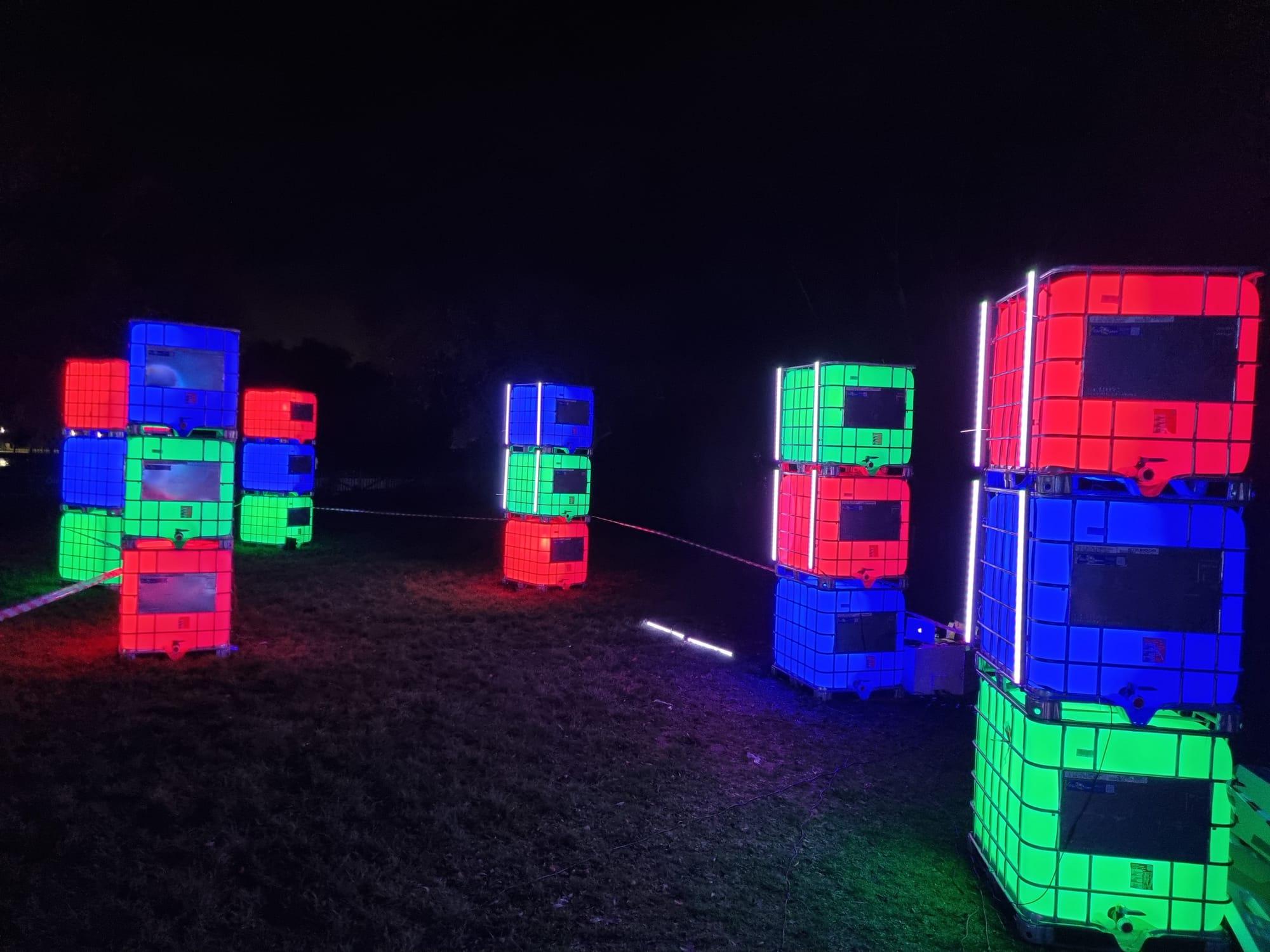 Stacked RGB-illuminated cube structures on a light trail